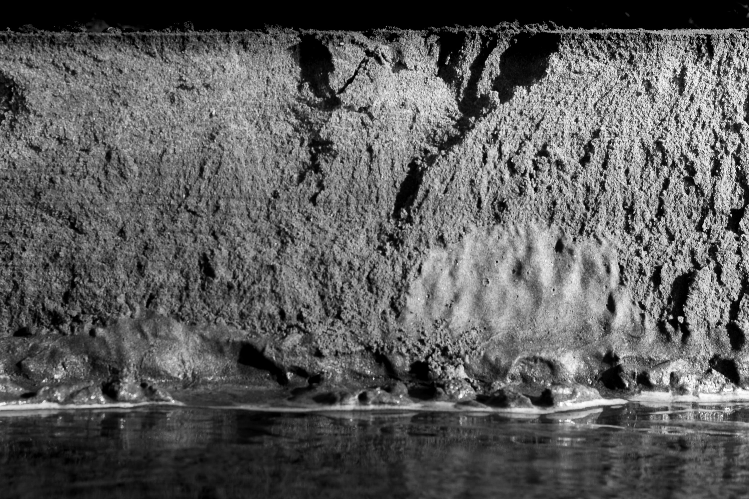 An eroded bluff reflected in still water