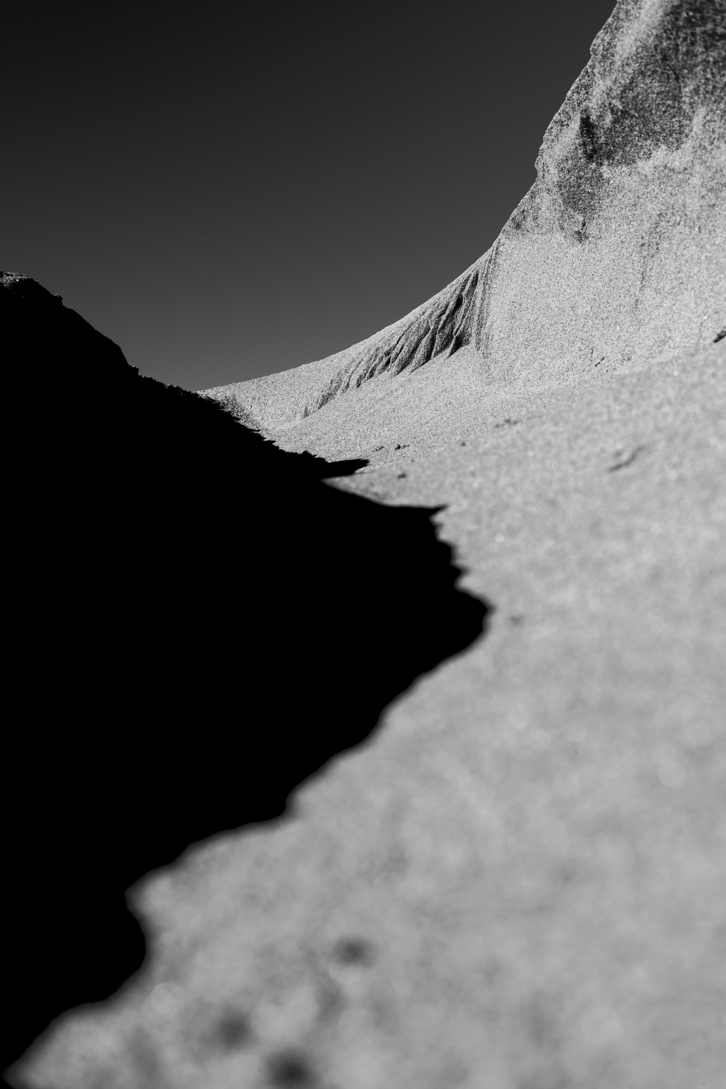 A sharp sand ridge throwing a deep black shadow
